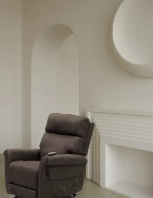 Brown recliner chair in a room with a fireplace.