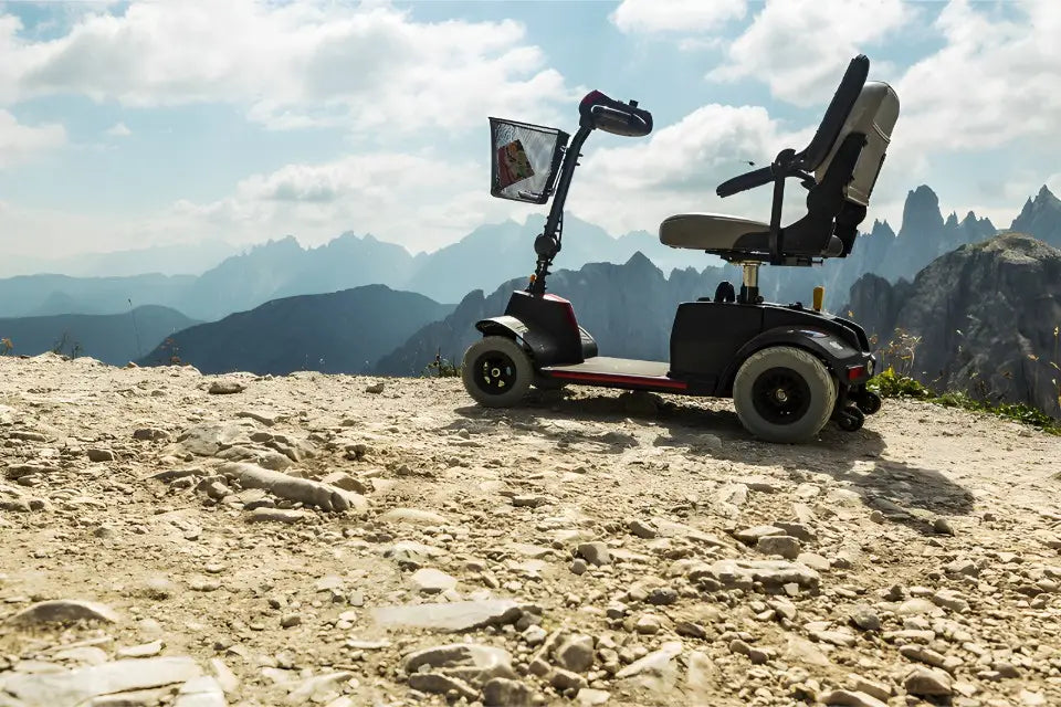 Mobility scooter on a mountainous landscape with clouds in the sky